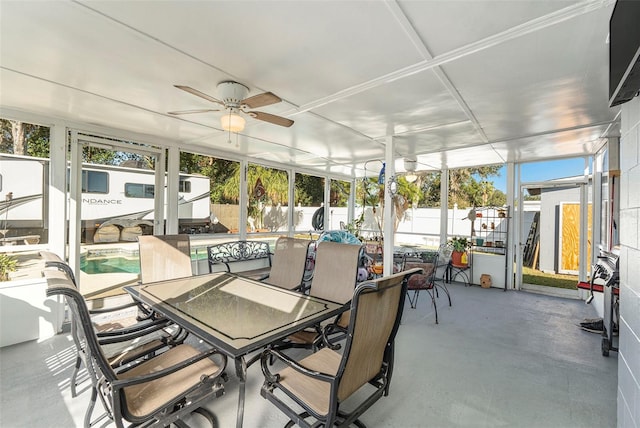 sunroom / solarium featuring ceiling fan