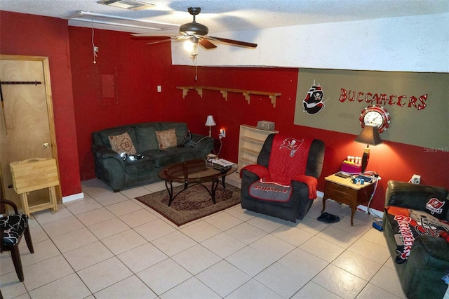 tiled living room with a textured ceiling and ceiling fan