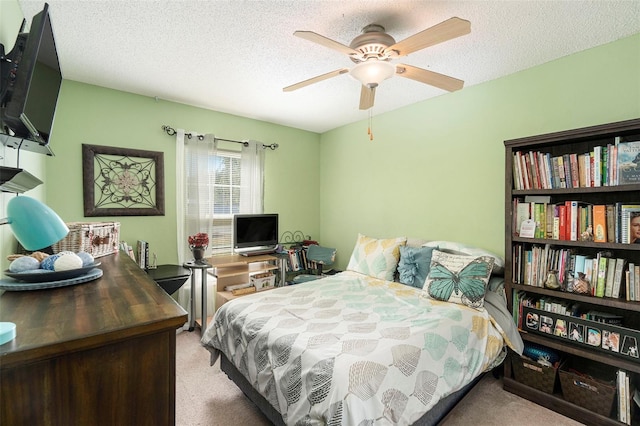 carpeted bedroom with ceiling fan and a textured ceiling