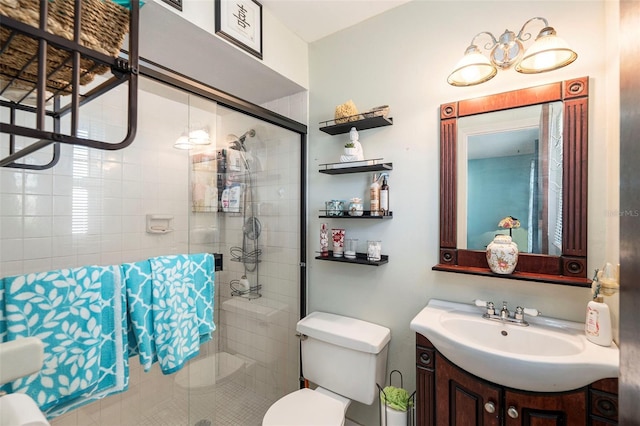 bathroom featuring vanity, toilet, and walk in shower