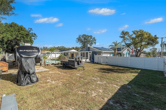 view of yard with a fenced in pool and a sunroom