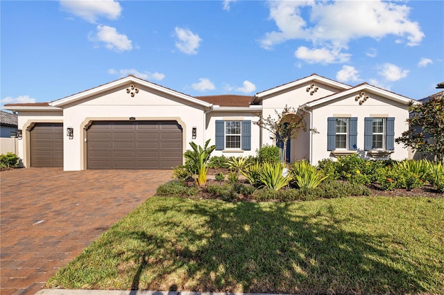 view of front of property with a garage and a front lawn