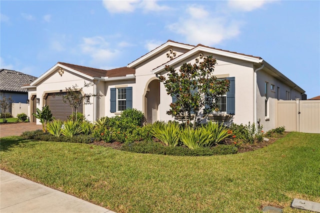 view of front of property featuring a front lawn and a garage