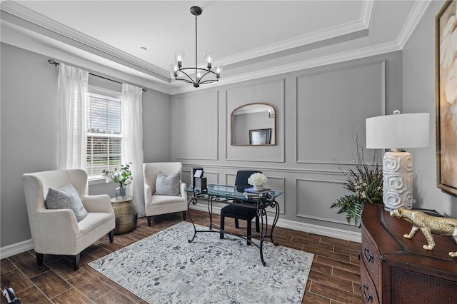 living area featuring dark hardwood / wood-style floors, a raised ceiling, ornamental molding, and a chandelier