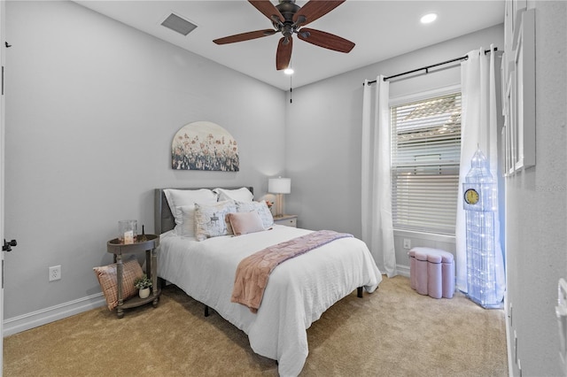 bedroom with ceiling fan and light colored carpet