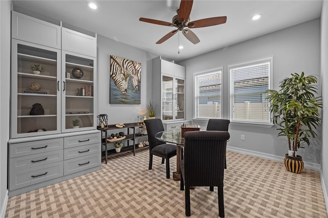 carpeted dining space featuring ceiling fan