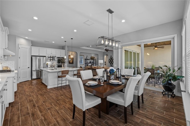 dining area featuring dark hardwood / wood-style flooring and ceiling fan