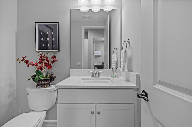 bathroom featuring vanity and toilet