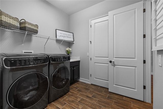 washroom with cabinets, washer and clothes dryer, and dark wood-type flooring