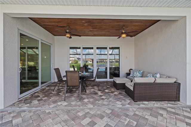 view of patio with an outdoor living space and ceiling fan