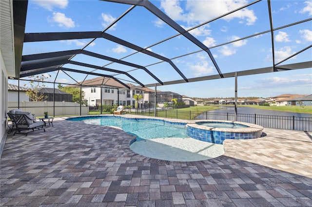 view of swimming pool with a lanai, a patio, and an in ground hot tub