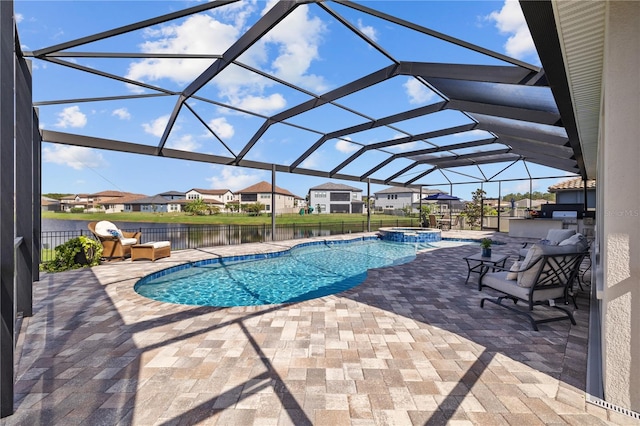 view of pool with an in ground hot tub, a lanai, a patio, and a water view