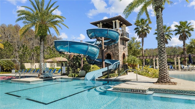 view of pool with a patio area, a pergola, and a water slide