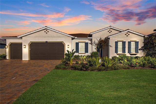 single story home with a lawn and a garage