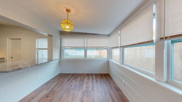 unfurnished sunroom featuring vaulted ceiling