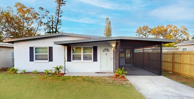 single story home with a carport and a front lawn