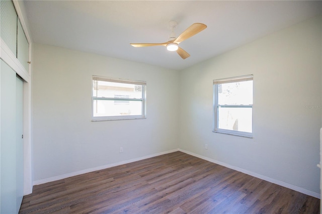 unfurnished room with dark hardwood / wood-style floors and ceiling fan