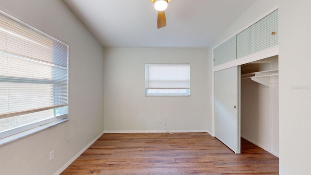 unfurnished bedroom with wood-type flooring, a closet, and ceiling fan