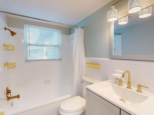 full bathroom with vanity, toilet, shower / bath combo, and tile walls