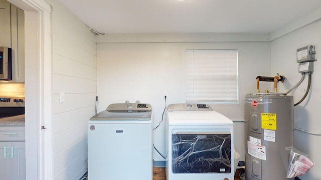 clothes washing area featuring separate washer and dryer and electric water heater