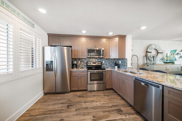 kitchen featuring dark hardwood / wood-style floors, sink, stainless steel appliances, and a wealth of natural light