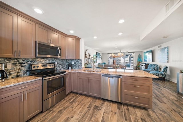 1591 Gulf Blvd Unit 504S, Clearwater Beach, FL 33767 - kitchen with stainless steel appliances, open floor plan, a peninsula, a sink, and recessed lighting