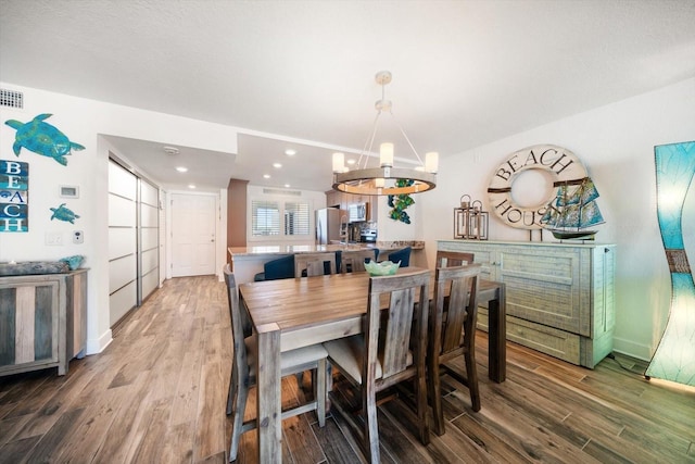 1591 Gulf Blvd Unit 504S, Clearwater Beach, FL 33767 - dining area featuring a chandelier, wood finished floors, recessed lighting, and baseboards