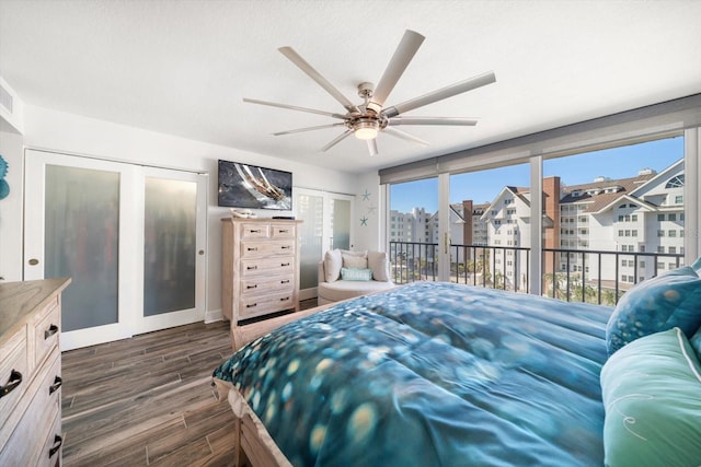 1591 Gulf Blvd Unit 504S, Clearwater Beach, FL 33767 - bedroom with access to exterior, dark wood-style floors, two closets, and ceiling fan