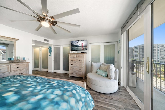 1591 Gulf Blvd Unit 504S, Clearwater Beach, FL 33767 - bedroom with access to outside, wood finished floors, multiple closets, and a ceiling fan