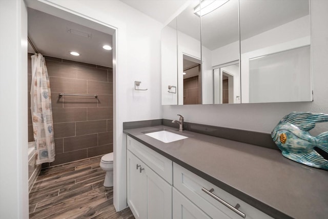 1591 Gulf Blvd Unit 504S, Clearwater Beach, FL 33767 - full bath with wood finished floors, toilet, vanity, recessed lighting, and tiled shower / bath combo