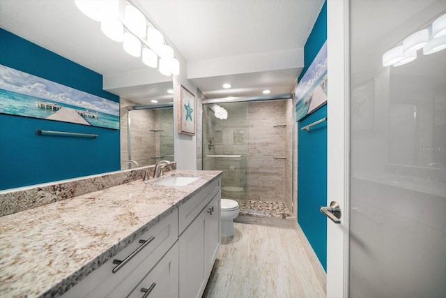 1591 Gulf Blvd Unit 504S, Clearwater Beach, FL 33767 - full bathroom featuring vanity, a stall shower, toilet, wood finished floors, and recessed lighting