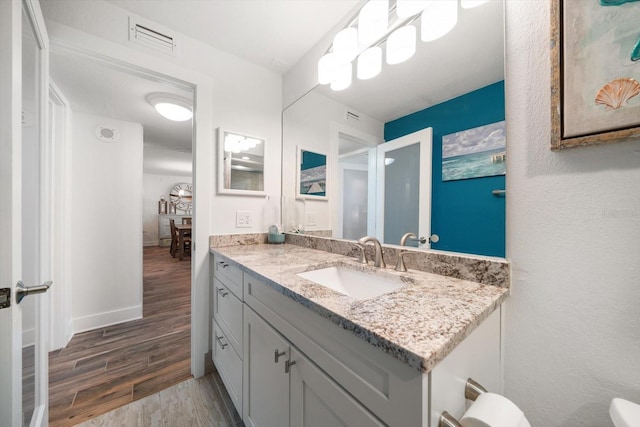1591 Gulf Blvd Unit 504S, Clearwater Beach, FL 33767 - bathroom featuring vanity, wood finished floors, and baseboards