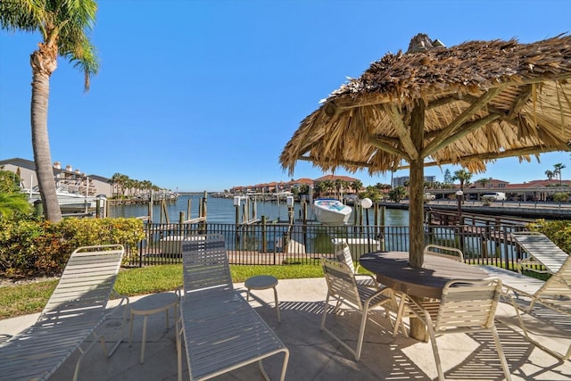 1591 Gulf Blvd Unit 504S, Clearwater Beach, FL 33767 - view of patio with boat lift, a boat dock, and a water view