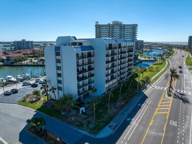 view of building exterior with a water view and a city view