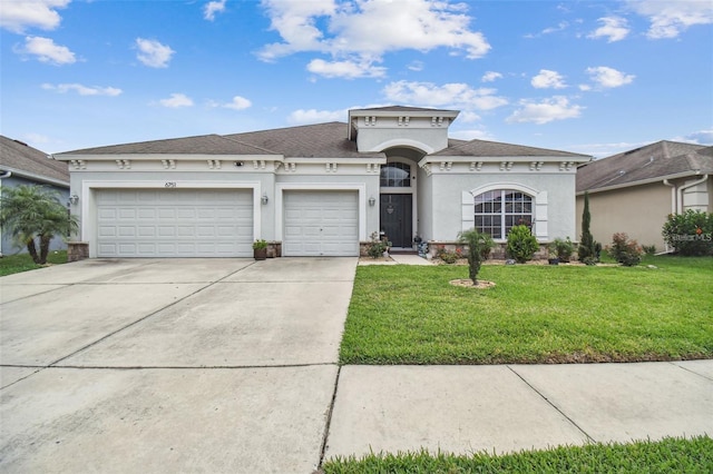 view of front of house with a garage and a front lawn