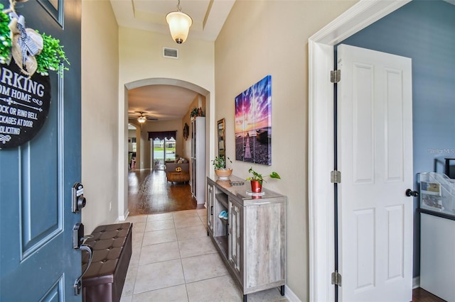 foyer entrance with ceiling fan and light hardwood / wood-style flooring