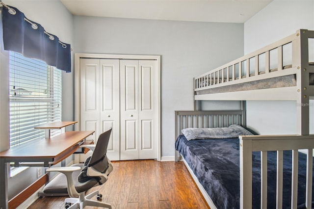 bedroom with hardwood / wood-style floors and a closet