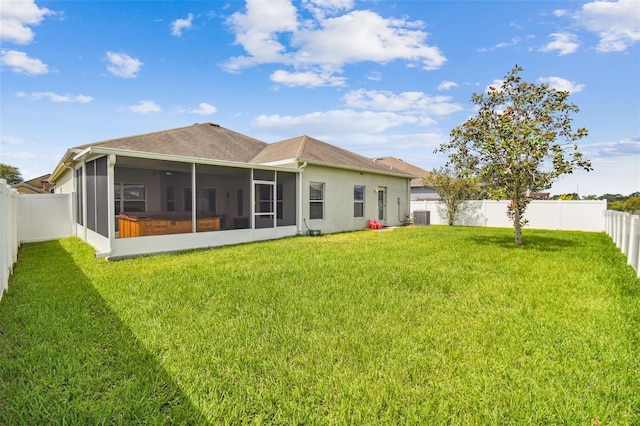 back of house with a sunroom, a yard, and central air condition unit