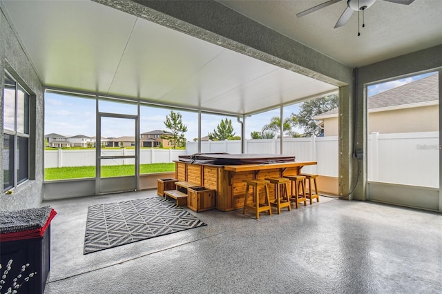 sunroom featuring plenty of natural light and ceiling fan