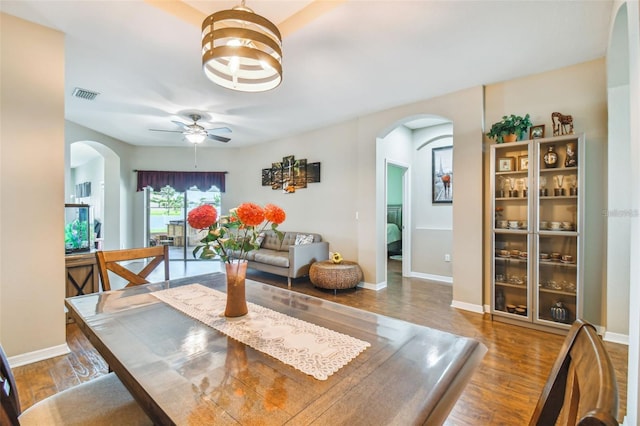 dining area with hardwood / wood-style flooring and ceiling fan