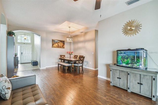 dining area with wood-type flooring and ceiling fan