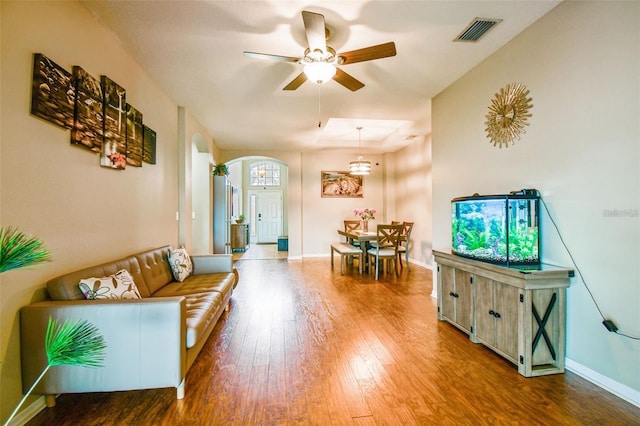 living room featuring hardwood / wood-style floors and ceiling fan