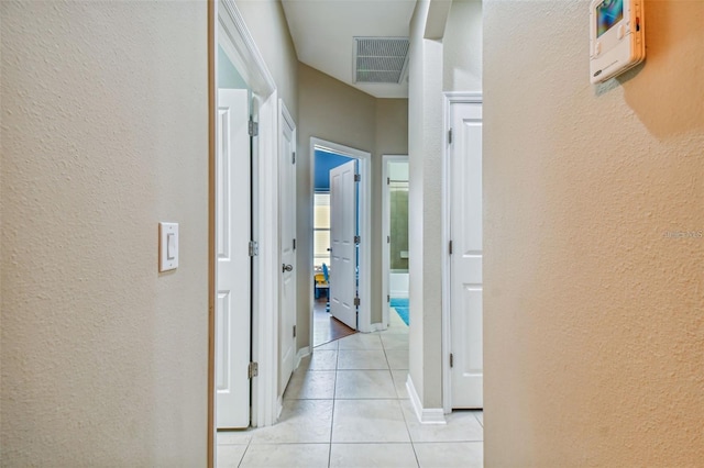 corridor with light tile patterned floors