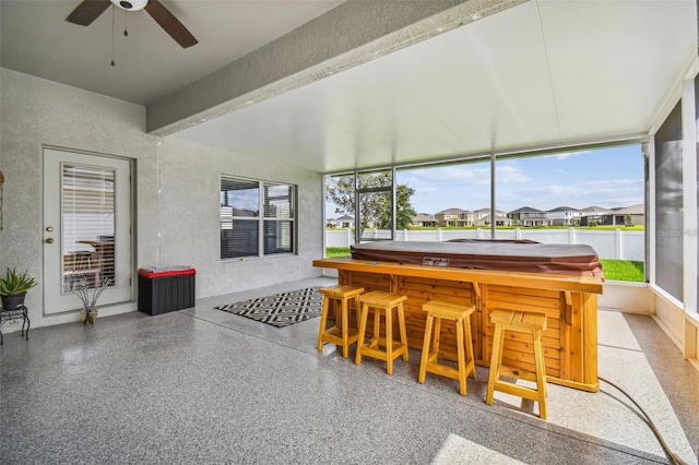 sunroom / solarium featuring a wealth of natural light and ceiling fan