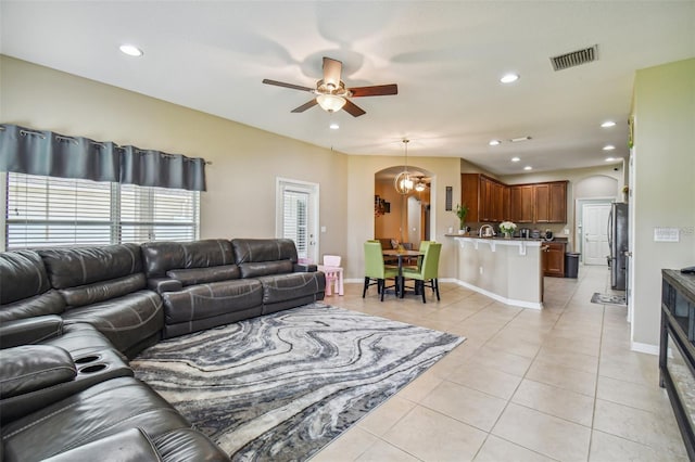 tiled living room featuring ceiling fan