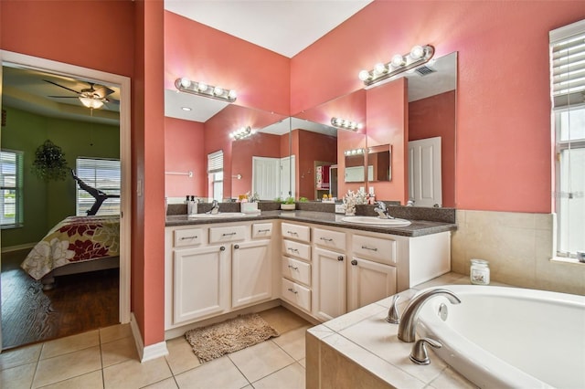 bathroom with tile patterned floors, vanity, a healthy amount of sunlight, and ceiling fan