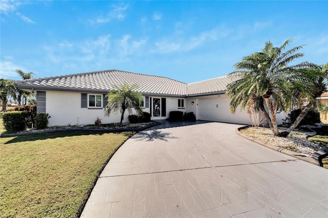 view of front of house featuring a garage and a front yard