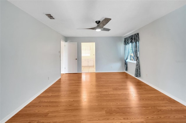 empty room featuring light wood-type flooring and ceiling fan