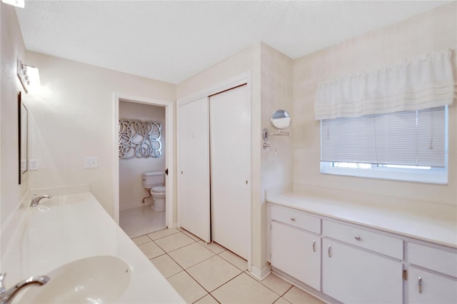 bathroom featuring tile patterned floors, vanity, and toilet