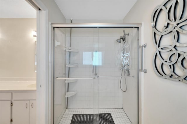 bathroom with tile patterned floors, vanity, and an enclosed shower